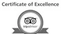 This image is a Certificate of Excellence from TripAdvisor, displaying their logo in the center with a ribbon design at the bottom. logo on footer section.